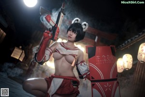 A woman in a red and white outfit holding a sword.