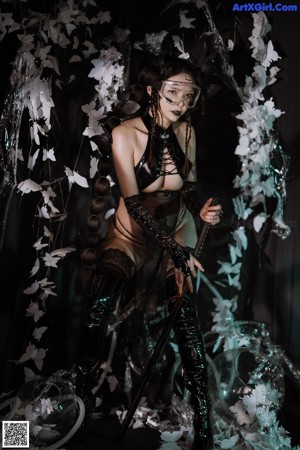 A woman in a black lingerie holding a sword.