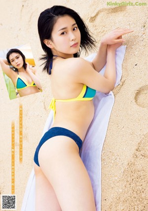 A woman in a white bikini posing by a pool.