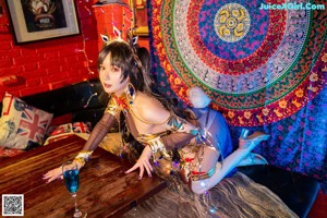 A woman in a costume sitting on a chair.
