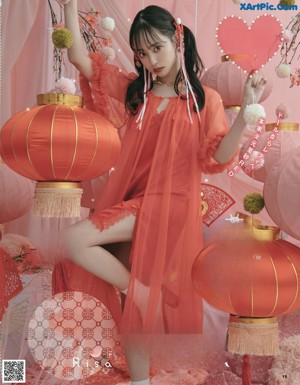 A woman in a red dress holding a red lantern.