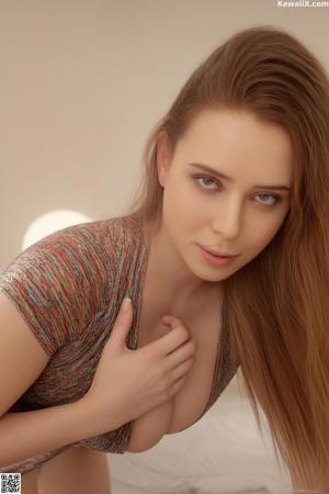 A woman in a blue sweater and plaid skirt sitting on a bed.