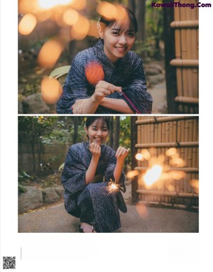 A woman in a kimono holding a sparkler in her hand.