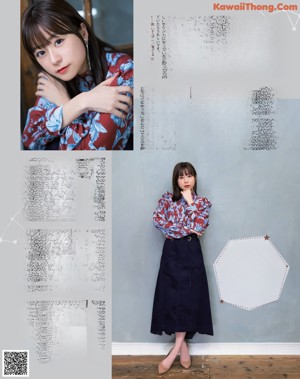 A woman in a purple shirt is posing for a magazine.