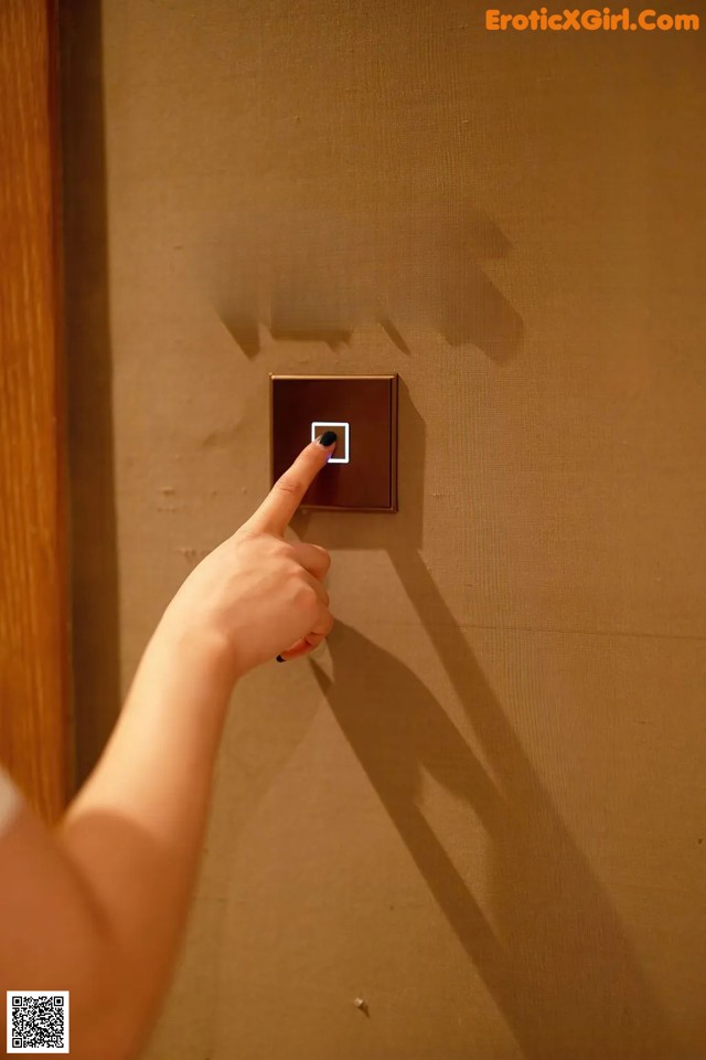 A person is pressing a button on a door.